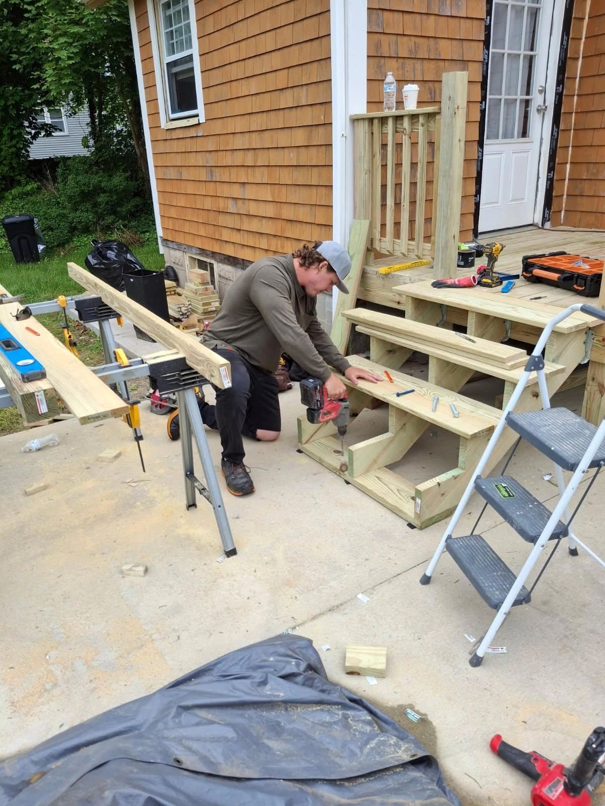 Nate Algar building a set of wooden stairs on a job site in Oakdale, CT