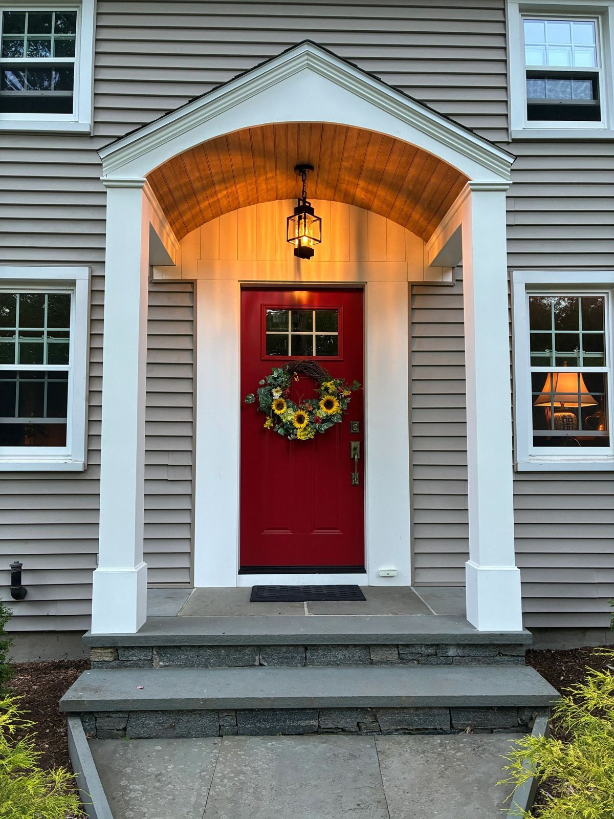 Finished front portico entry addition with red door in New London County, CT