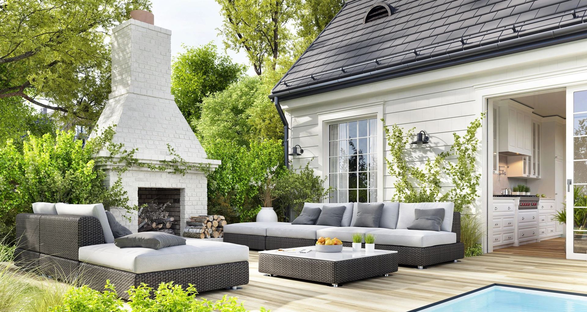 Outdoor living patio with seating and fireplace in southeastern CT