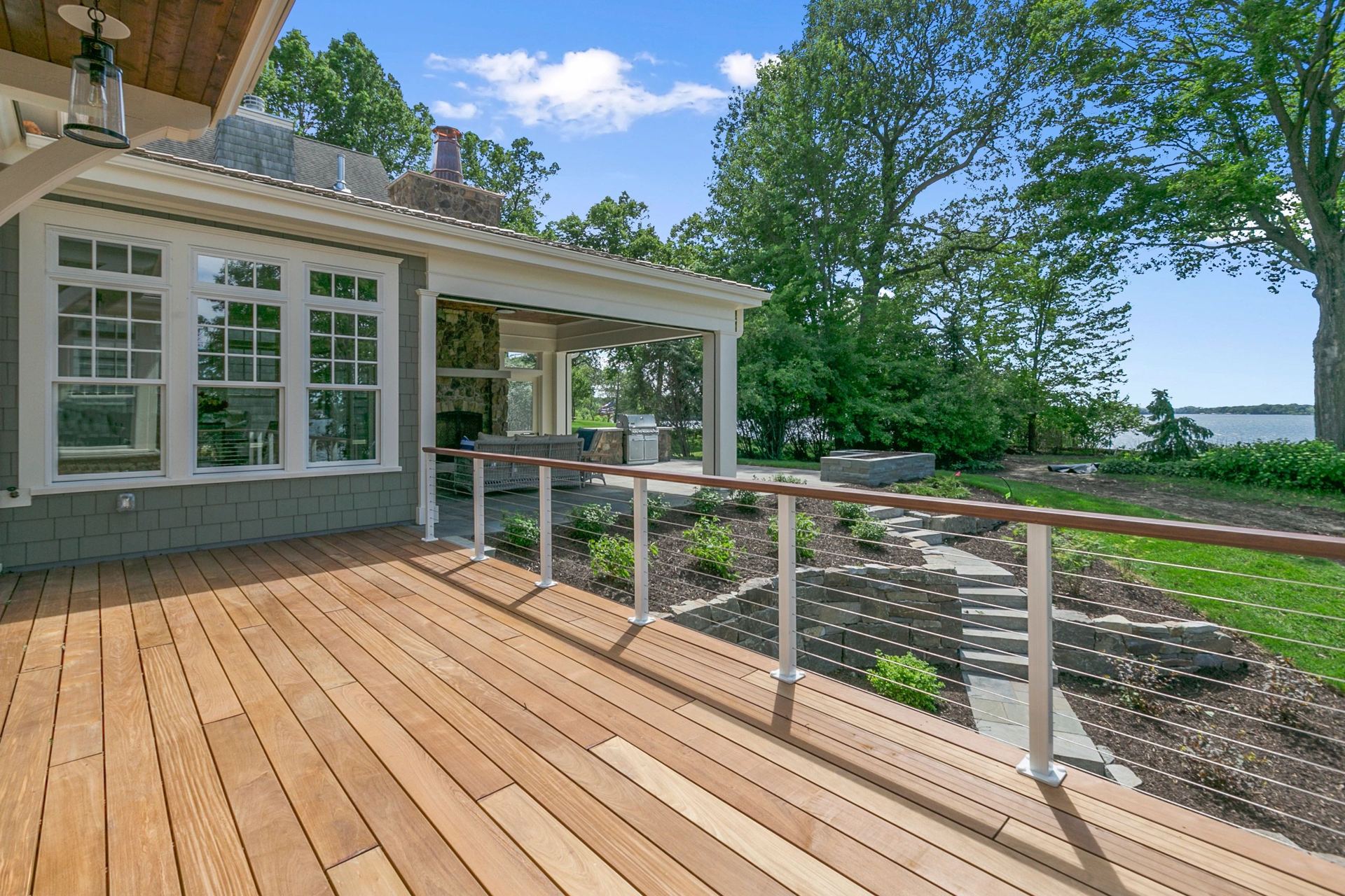 Wood deck with cable railing overlooking a wooded yard in New London County, CT